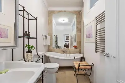a bathroom with a tub and a toilet and a sink at Unique sea view apartment, center, 100m2 in Nice