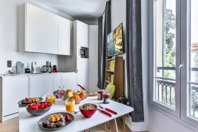 a white kitchen with fruit on a white table at MY CASA - 46 GIOFFREDO - Central 1 bedroom in Nice