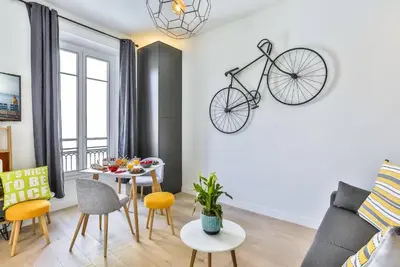 a living room with a table and a bike on the wall at MY CASA - 46 GIOFFREDO - Central 1 bedroom in Nice