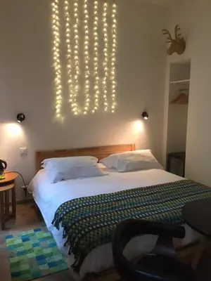 a bedroom with a bed with lights on the wall at Little Palace in Nice