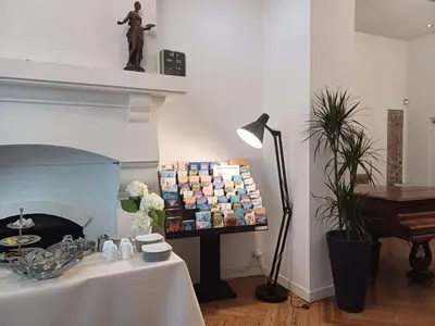 a room with a table and a fireplace and a piano at Little Palace in Nice