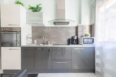 a kitchen with silver cabinets and a sink at NOTRE DAME - Huge sunny modern 2BR flat - Terrace in Nice