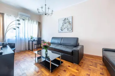 a living room with a leather couch and a table at NOTRE DAME - Huge sunny modern 2BR flat - Terrace in Nice