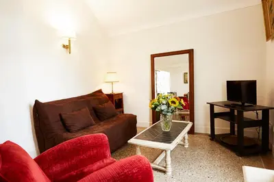 a bedroom with a desk and a bed and a chair at Résidence La Villa Léonie in Nice