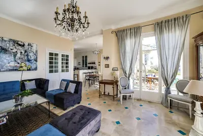 a living room with a couch and a table at Villa Dracoena in Nice