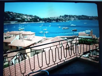 a view of a harbor with boats in the water at The Dina Palace. in Villefranche-sur-Mer