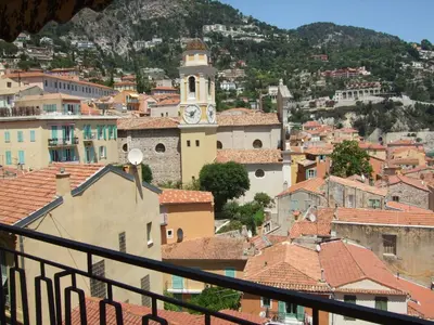 a balcony with a table and a view of the water at The Dina Palace. in Villefranche-sur-Mer