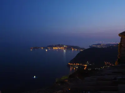 a view of a large body of water at night at La Suite du Village d'Eze in Èze