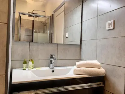 a bathroom with a sink and a mirror at Nestor&Jeeves - CAESARS - Hyper center - Shopping avenue in Nice