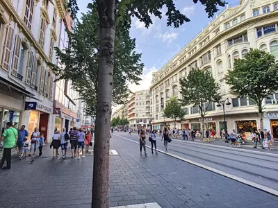 a group of people walking down a city street at Nestor&Jeeves - CAESARS - Hyper center - Shopping avenue in Nice