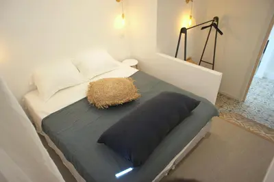 a bed with a pillow on it in a room at Ze Perfect Place - Vieux Nice - Exceptionnel Appartement - Calme et Terrasse avec vues in Nice