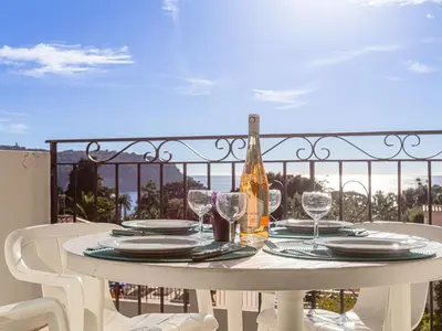 a resort with a lawn and palm trees at Apartment L'Ange Gardien-2 by Interhome in Beaulieu-sur-Mer
