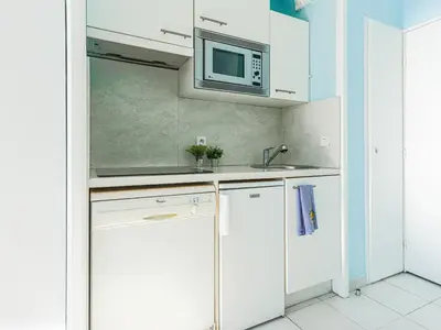 a blue room with a bed and a balcony at Apartment L'Ange Gardien-2 by Interhome in Beaulieu-sur-Mer