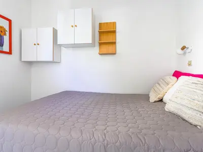 a small kitchen with a couch and a microwave at Apartment L'Ange Gardien-2 by Interhome in Beaulieu-sur-Mer