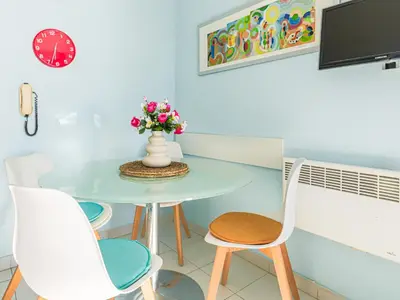 a bedroom with a large bed with pink accents at Apartment L'Ange Gardien-2 by Interhome in Beaulieu-sur-Mer