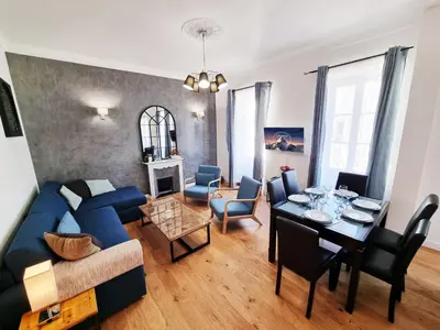 a living room with a blue couch and a table at 