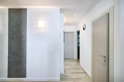 a hallway with white walls and wood floors at 