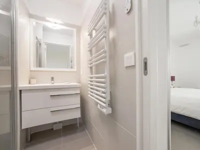 a bathroom with a sink and a mirror at Residence Blue Harmony in Nice