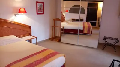 a hotel room with two beds and a mirror at Chambres d'hôtes Les Terrasses du Soleil in Cagnes-sur-Mer
