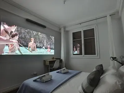 a bedroom with a bed and a large tv on the wall at Nestor&Jeeves - FIORA PARADISE TERRACE - Central - Very close sea in Nice
