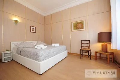 a bedroom with a large bed and a chair at Suite Gioia five stars holiday house in Nice