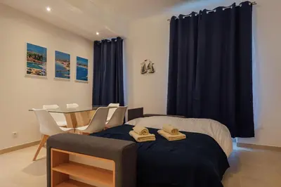a bedroom with a bed and a table and chairs at 