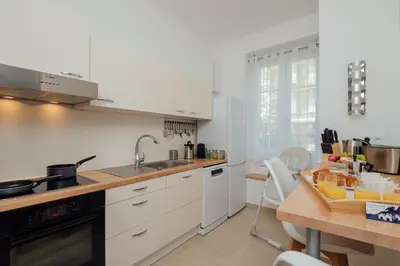 a kitchen with white cabinets and a wooden table at 