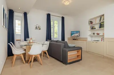 a living room with a couch and a table and chairs at 