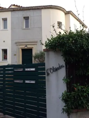 a house with a black gate and a fence at 