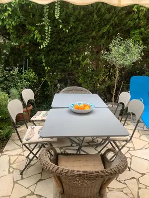 a table and chairs with a bowl of fruit on it at 