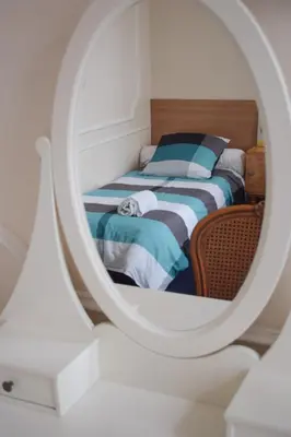 a bedroom with a bed and a mirror at Hôtel Belle Meunière in Nice