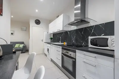 a kitchen with white cabinets and a microwave and appliances at Charming 1 Bdr Old town in Nice