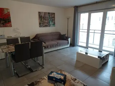 a living room with a couch and a table at Promenade Gambetta in Nice