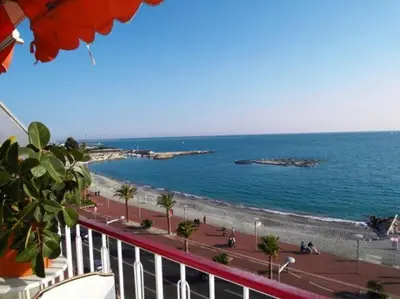 a view of the beach and the ocean from a balcony at Cros De Cagnes in Cagnes-sur-Mer