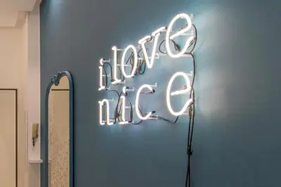a neon sign that says hello me on a wall at COURS SALEYA Renovated 3 Bedrooms 1 min to Beach Air Conditioning in Nice