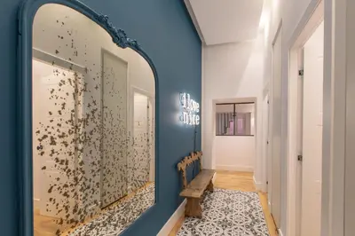 a hallway with a large mirror and a bench at COURS SALEYA Renovated 3 Bedrooms 1 min to Beach Air Conditioning in Nice