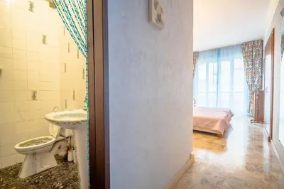 a bathroom with a sink and a toilet in a room at Big apart 140m2 5min walk to beach sea &Promenade 3 double rooms,big living room 42m2, 3 showers,9 beds, free parking in Nice