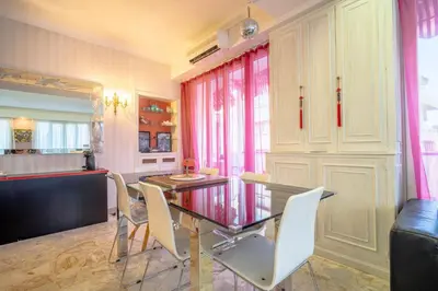 a dining room with a glass table and chairs at Big apart 140m2 5min walk to beach sea &Promenade 3 double rooms,big living room 42m2, 3 showers,9 beds, free parking in Nice