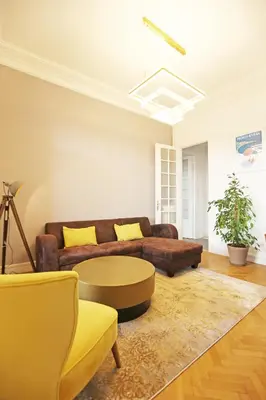 a living room with a couch and a table at Splendid apart in the heart of Nice in Nice