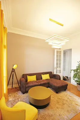 a living room with a brown couch and a table at Splendid apart in the heart of Nice in Nice