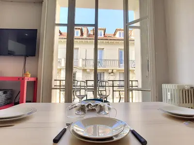 a dining table with a view of a building at Nestor&Jeeves - LILAS BUFFA - Central - Close sea - Top Floor in Nice
