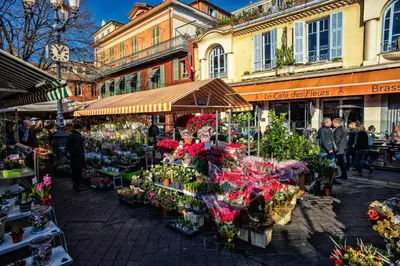 a group of people walking around a market with flowers at Nestor&Jeeves - LILAS BUFFA - Central - Close sea - Top Floor in Nice