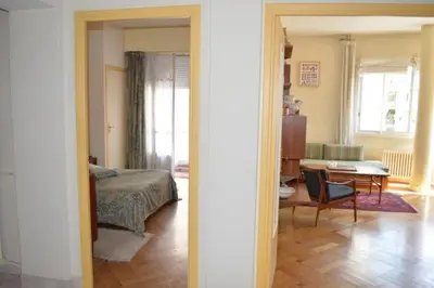 a bedroom and a living room with a bed and a table at Le Catinat in Nice