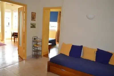a living room with a blue and yellow couch at Le Catinat in Nice