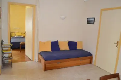a bedroom with a bed with blue and yellow pillows at Le Catinat in Nice