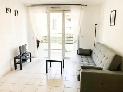 a living room with a couch and a table at Arson Riquier Port in Nice