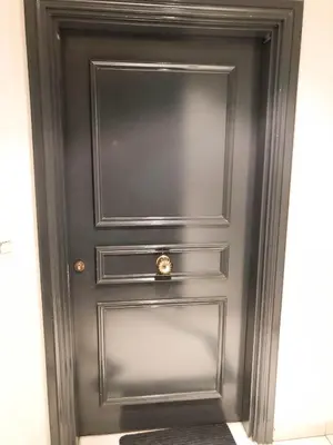 a black door with a brass knocker on it at Arson Riquier Port in Nice