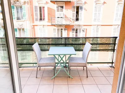 a table and chairs on the balcony of a building at Arson Riquier Port in Nice