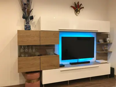 a flat screen tv sitting on top of a entertainment center at Rigoletto Massena in Nice