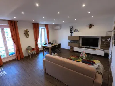 a living room with a couch and a table at Rigoletto Massena in Nice